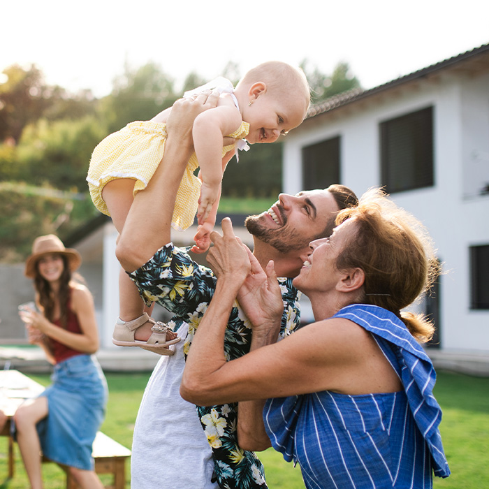 Happy family enjoying weather in backyard